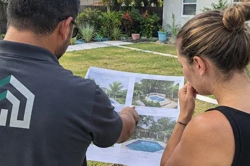 Outdoor designer reviewing backyard plans with a homeowner