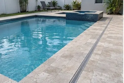 Finished paver pool deck with linear drainage