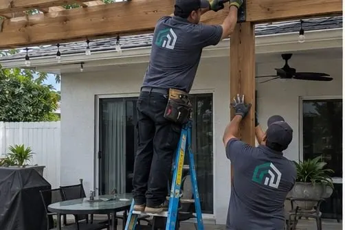 Hollywood Outdoor crew installing a cedar pergola at a South Florida home