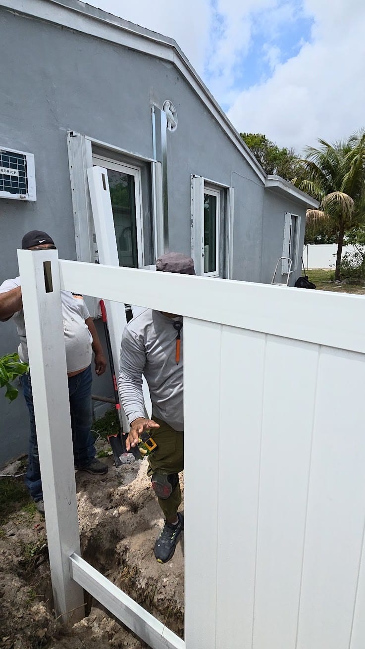 White vinyl fence installation around an outdoor living area in Hollywood, Florida